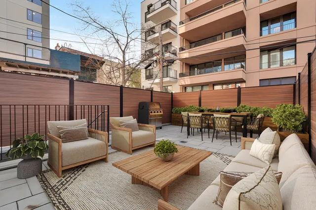 a living room with furniture kitchen view and a large window