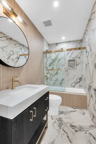 a bathroom with a toilet a sink and shower