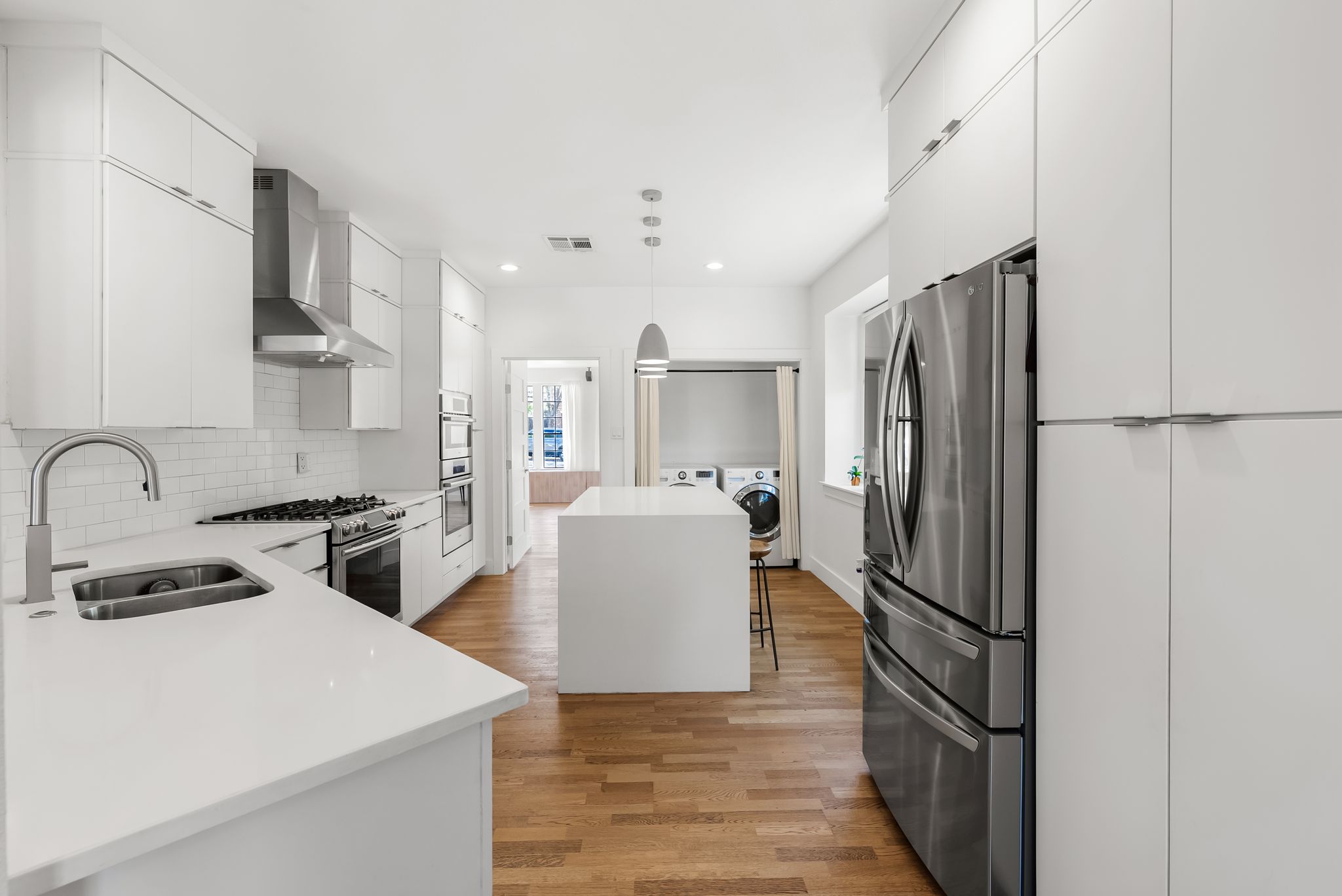 1714 Prairie Hen Cove Austin, TX 78758 - Photo 11 of 35 a kitchen with a refrigerator and a stove top oven