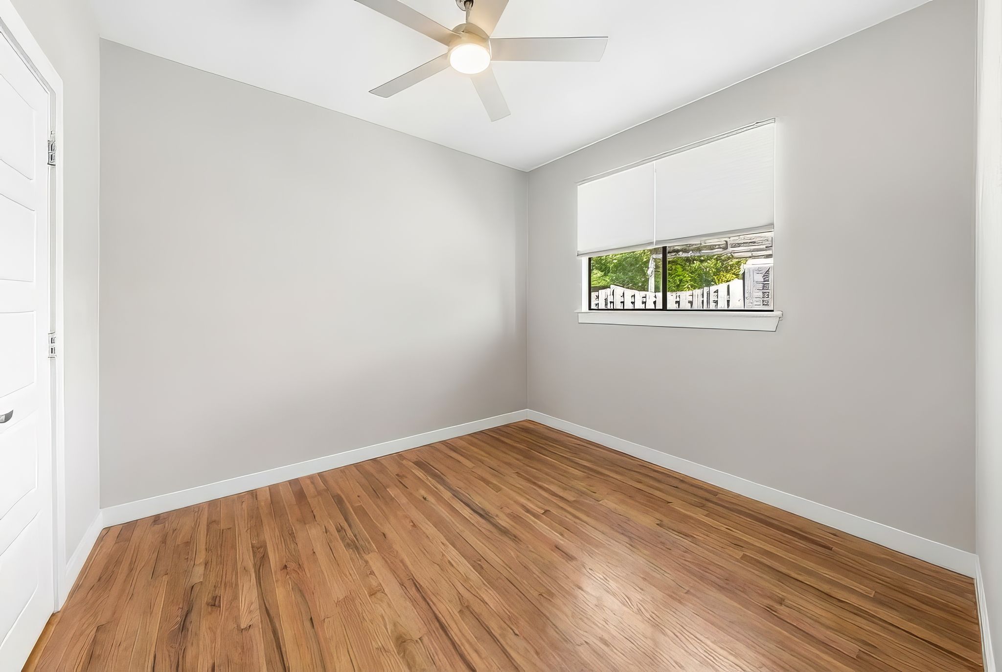 1714 Prairie Hen Cove Austin, TX 78758 - Photo 15 of 35 an empty room with a window and wooden floor