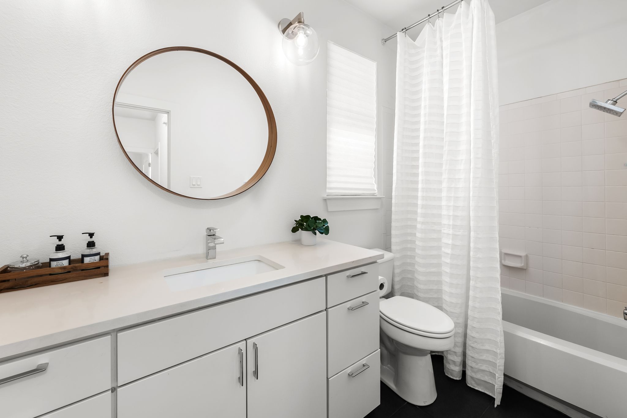 1714 Prairie Hen Cove Austin, TX 78758 - Photo 23 of 35 a bathroom with a sink a toilet and a mirror