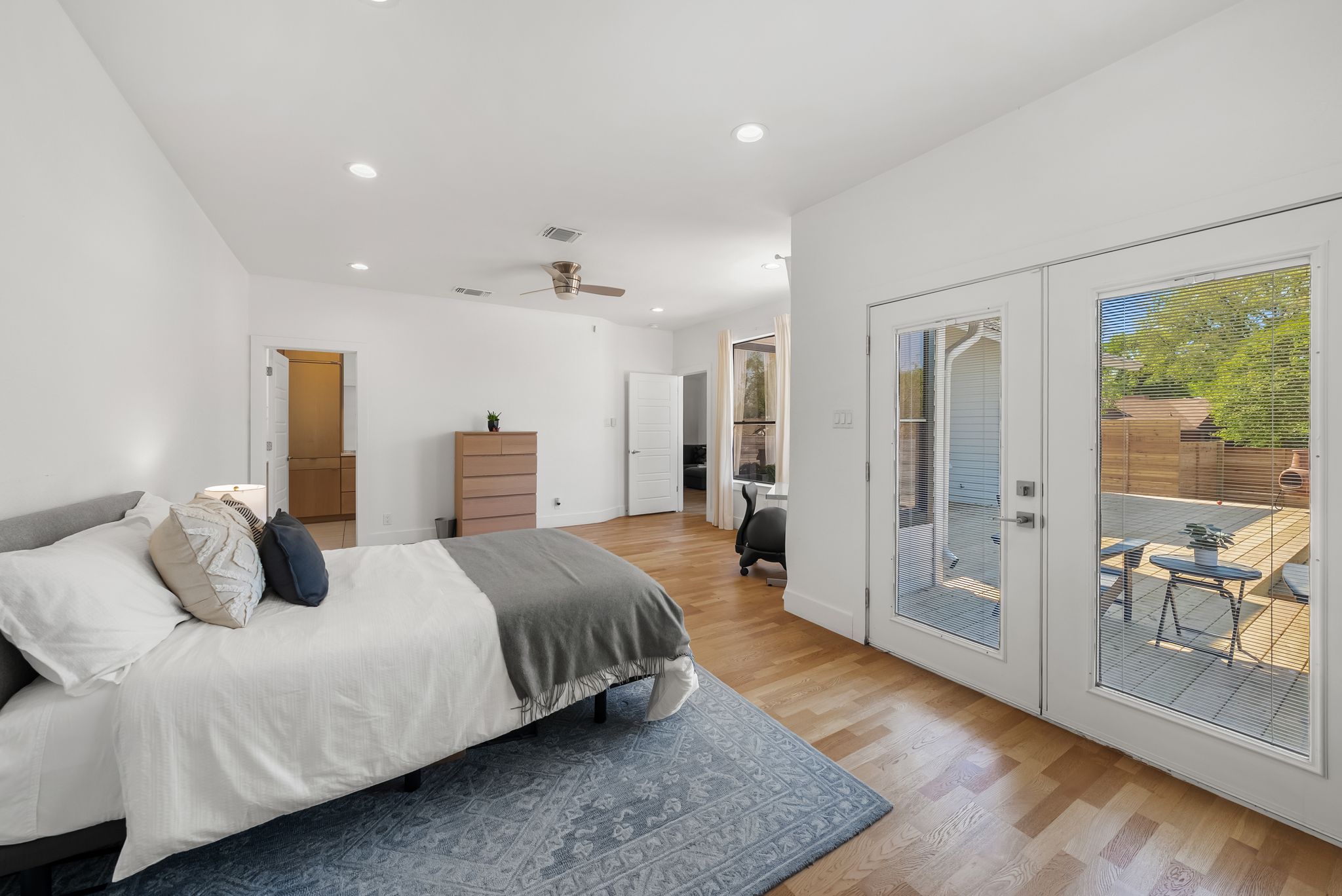 1714 Prairie Hen Cove Austin, TX 78758 - Photo 24 of 35 a bedroom with a large bed and a wooden floor