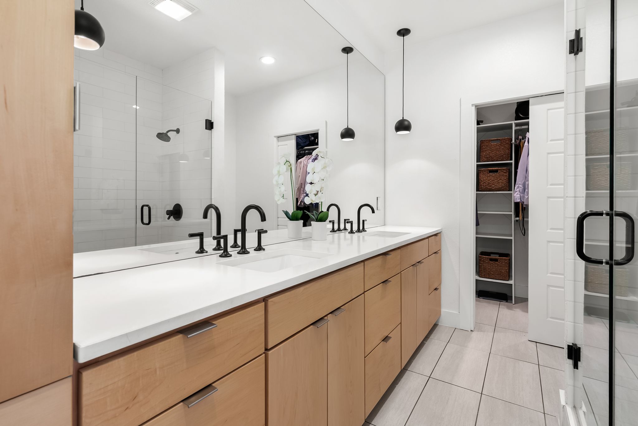1714 Prairie Hen Cove Austin, TX 78758 - Photo 25 of 35 a bathroom with a double vanity sink a mirror and a bathtub
