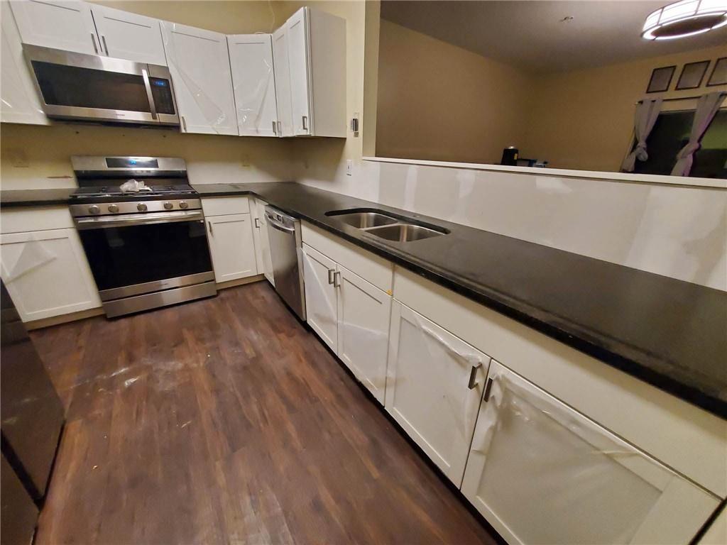 1749 Broad River Road Atlanta, GA 30349 - Photo 4 of 10 a kitchen with a sink and cabinets