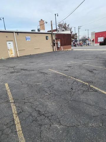 a view of a building with snow on the road