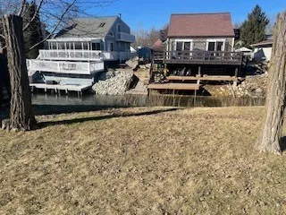 a view of a backyard with couches under an umbrella