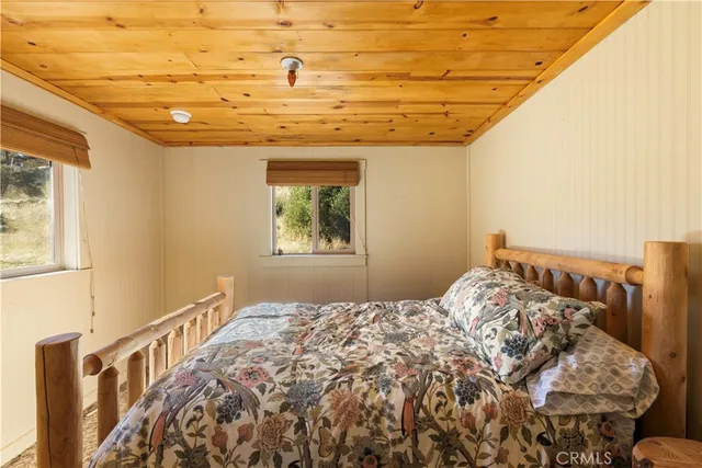 a bedroom with a bed and a curtain