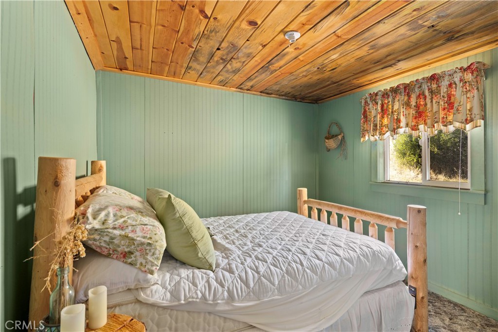 5200 Bartlett Springs Road Upper Lake, CA 95485 - Photo 18 of 36 a bed sitting in a bedroom next to a window