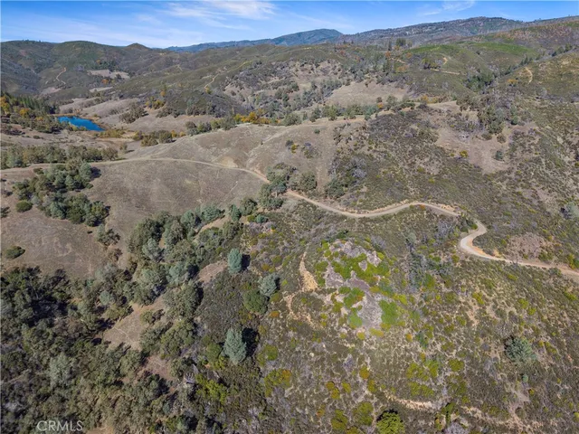 an aerial view of mountain with trees in the background