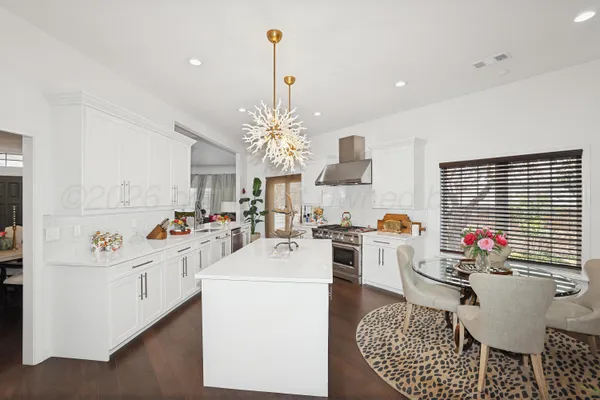 a kitchen with a stove and a white cabinets