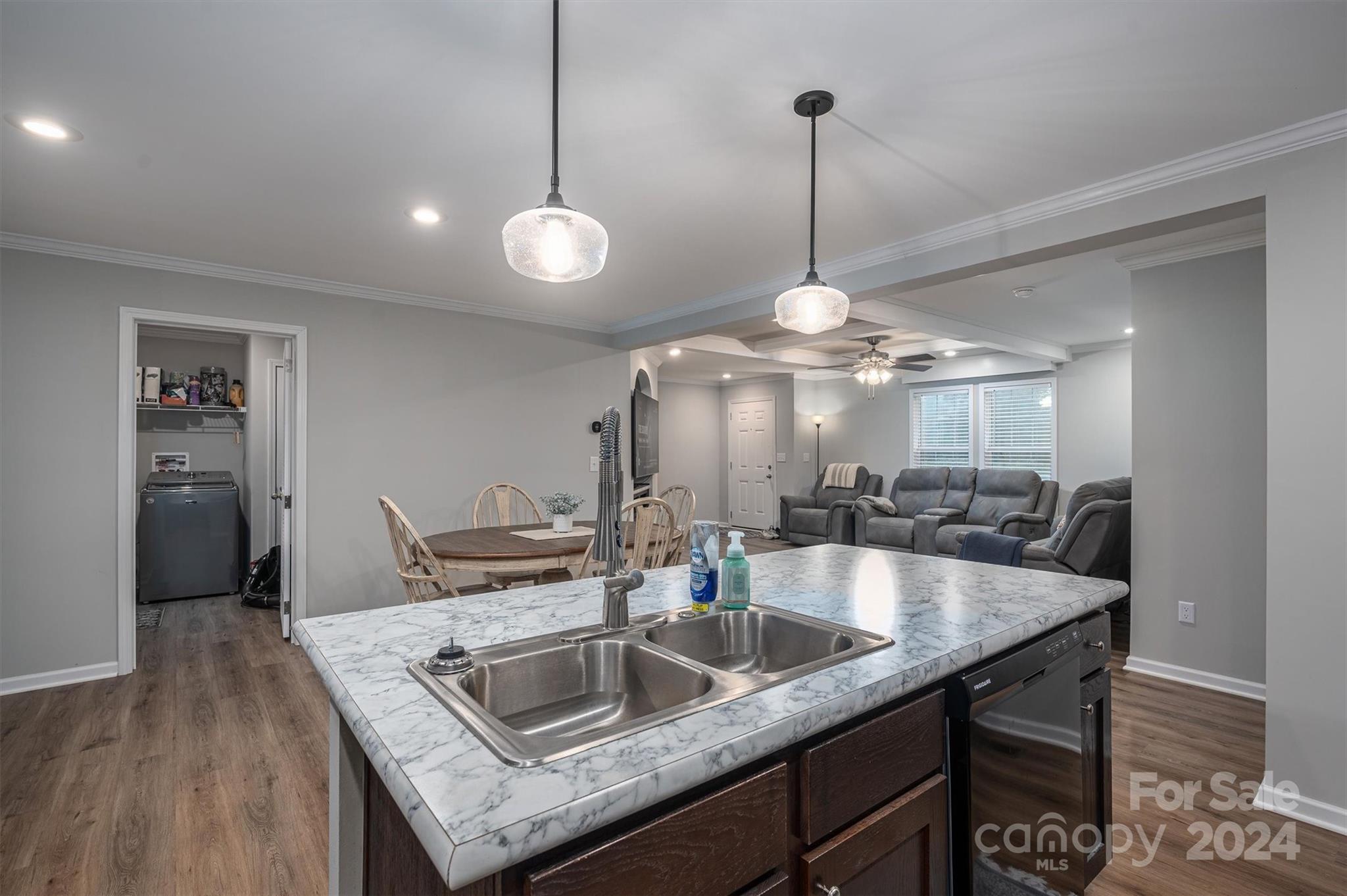 2388 Cat Square Road Vale, NC 28168 - Photo 15 of 33 a kitchen with center island a sink dishwasher a dining table and chairs with wooden floor