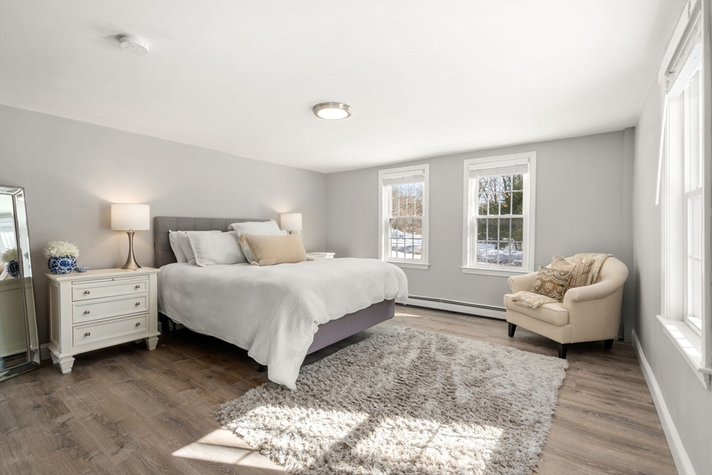 738 Whiting Street Hanover, MA 02339 - Photo 11 of 32 a bedroom with a bed and a couch