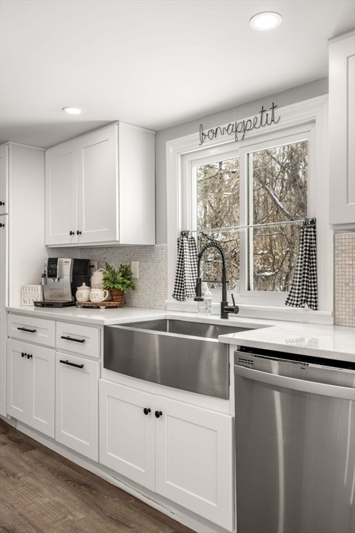 738 Whiting Street Hanover, MA 02339 - Photo 19 of 32 a kitchen with granite countertop a sink and white cabinets