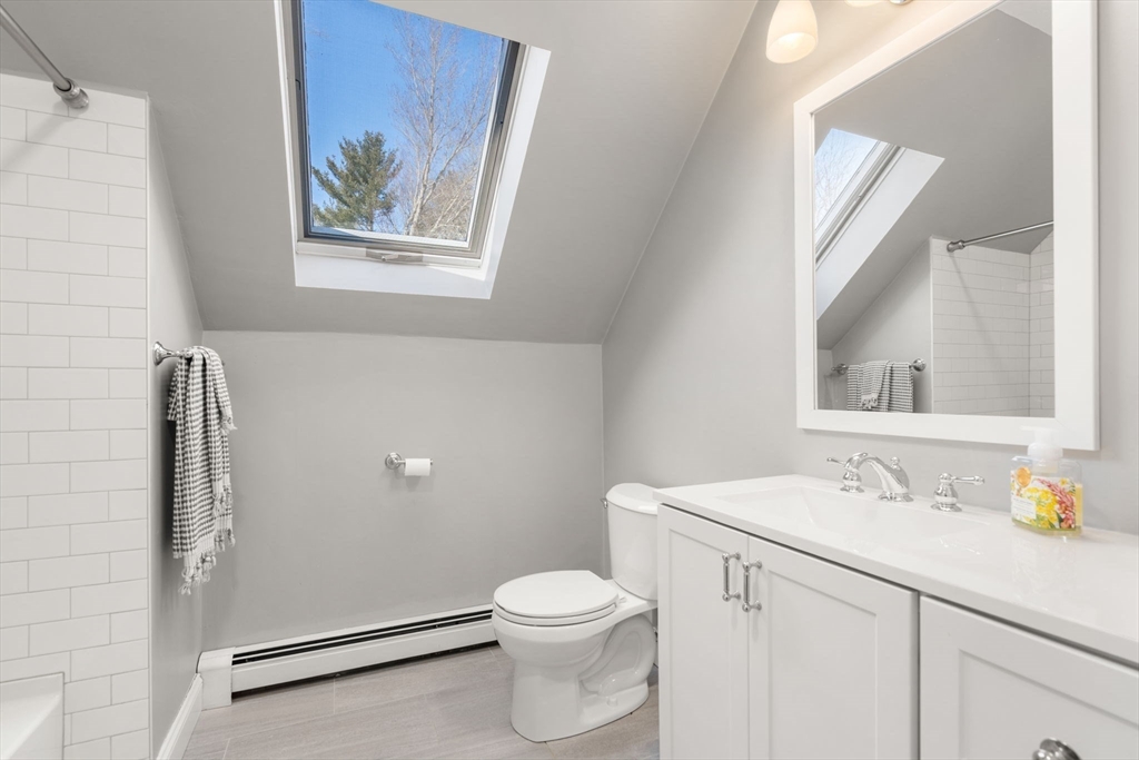738 Whiting Street Hanover, MA 02339 - Photo 22 of 32 a bathroom with a sink a toilet and a mirror