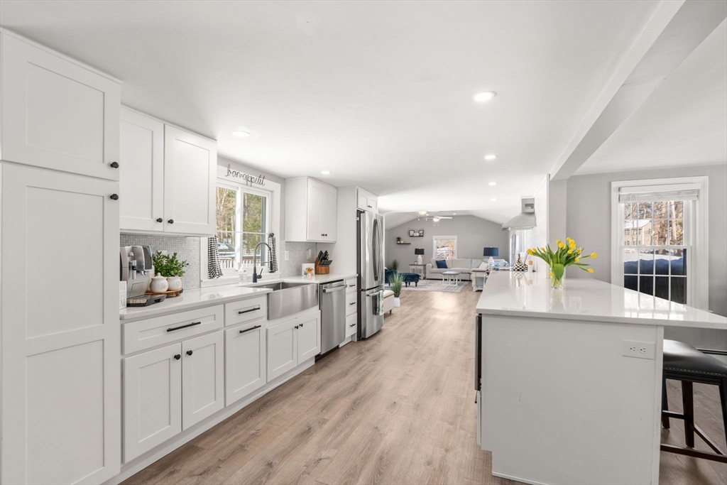 738 Whiting Street Hanover, MA 02339 - Photo 27 of 32 a large kitchen with lots of counter space a sink appliances and living room view