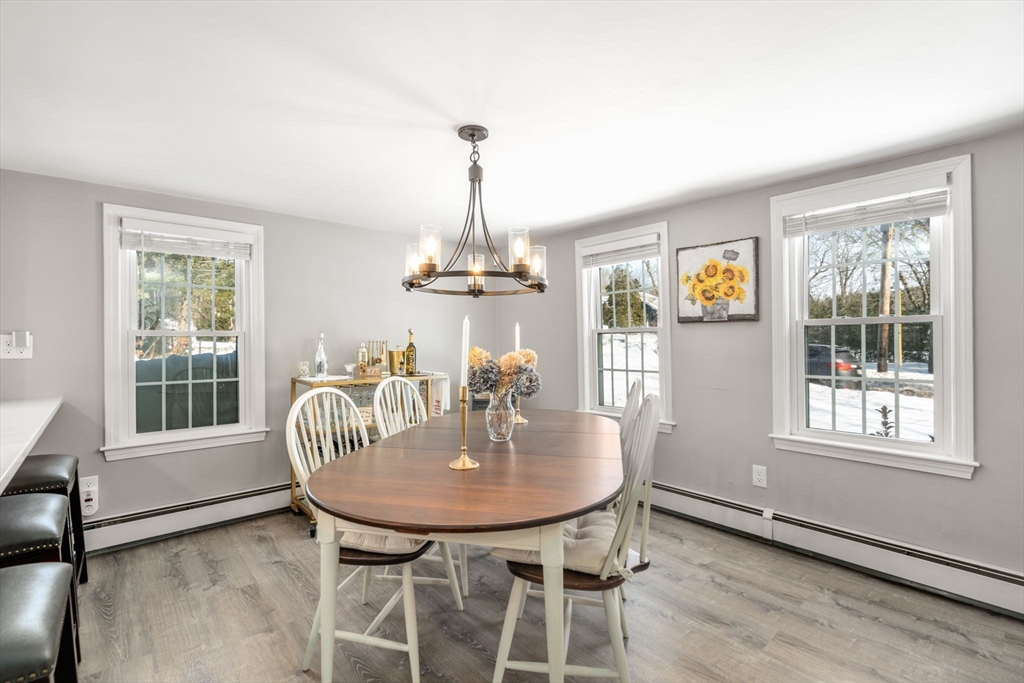 738 Whiting Street Hanover, MA 02339 - Photo 28 of 32 a dining room with furniture a chandelier and wooden floor