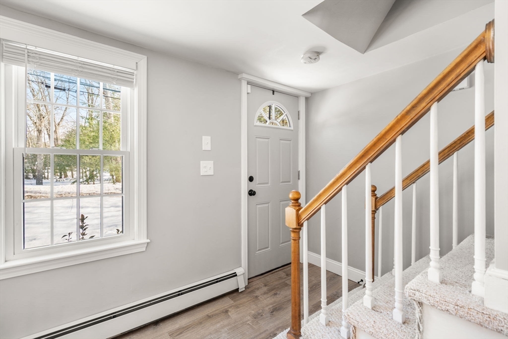 738 Whiting Street Hanover, MA 02339 - Photo 29 of 32 a view of an entryway with wooden floor and door
