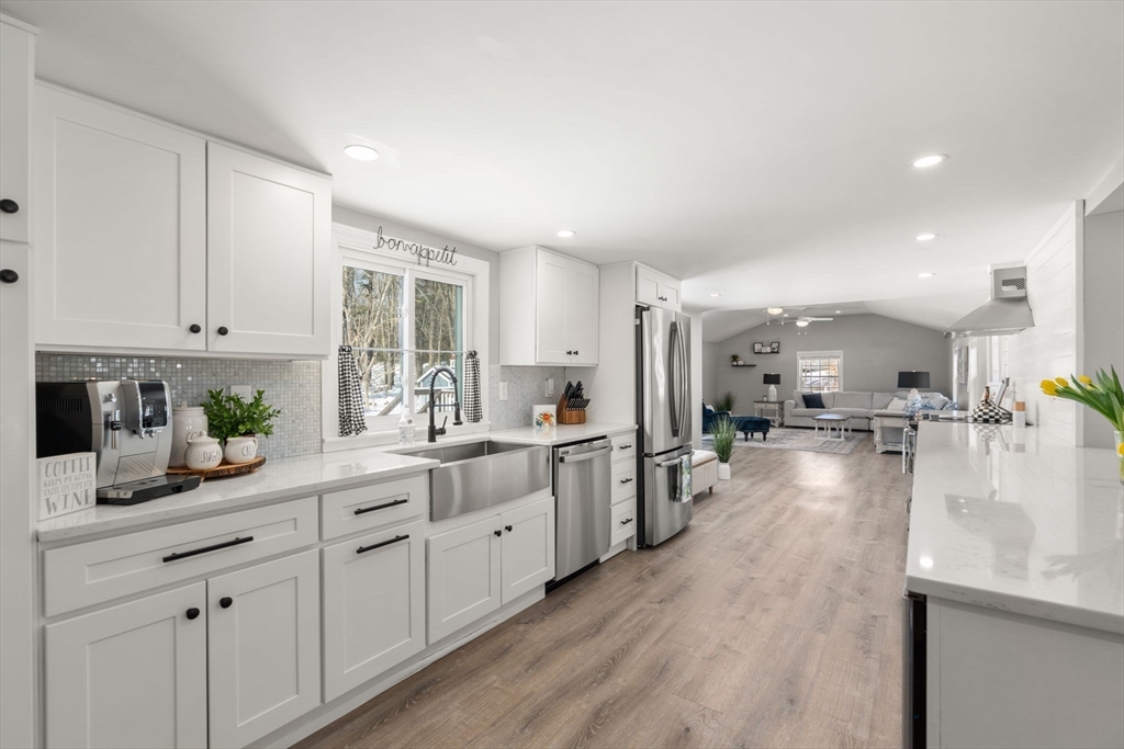 738 Whiting Street Hanover, MA 02339 - Photo 5 of 32 a view of a kitchen with kitchen island granite countertop lots of counter top space and stainless steel appliances