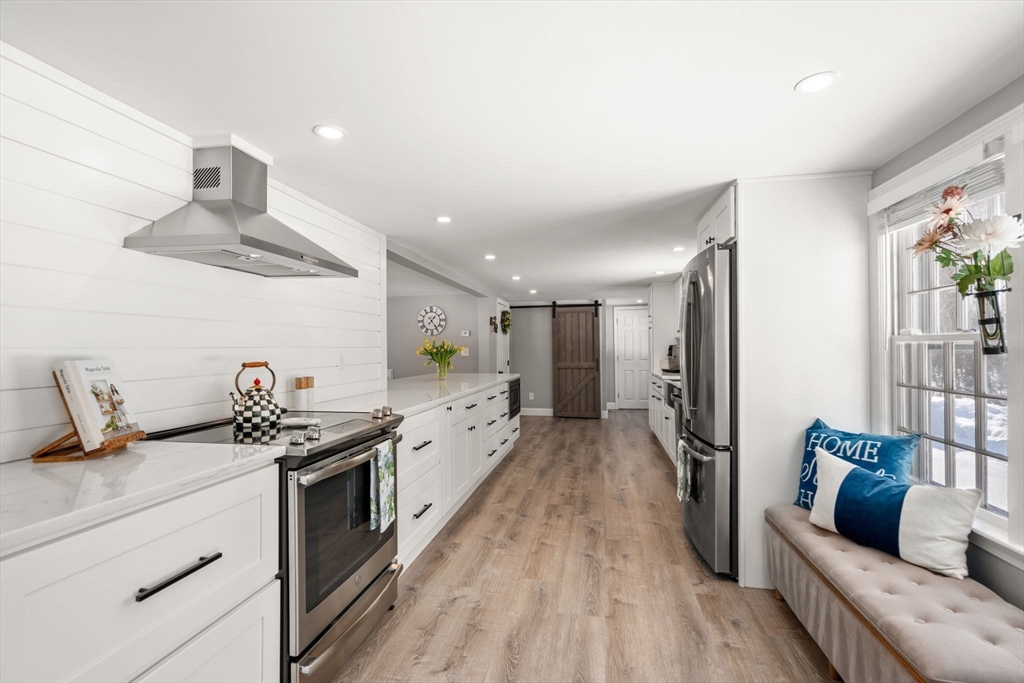 738 Whiting Street Hanover, MA 02339 - Photo 6 of 32 a kitchen with a sink stainless steel appliances and cabinets