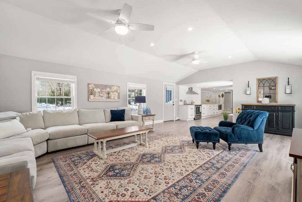 738 Whiting Street Hanover, MA 02339 - Photo 8 of 32 a living room with furniture a rug and a window