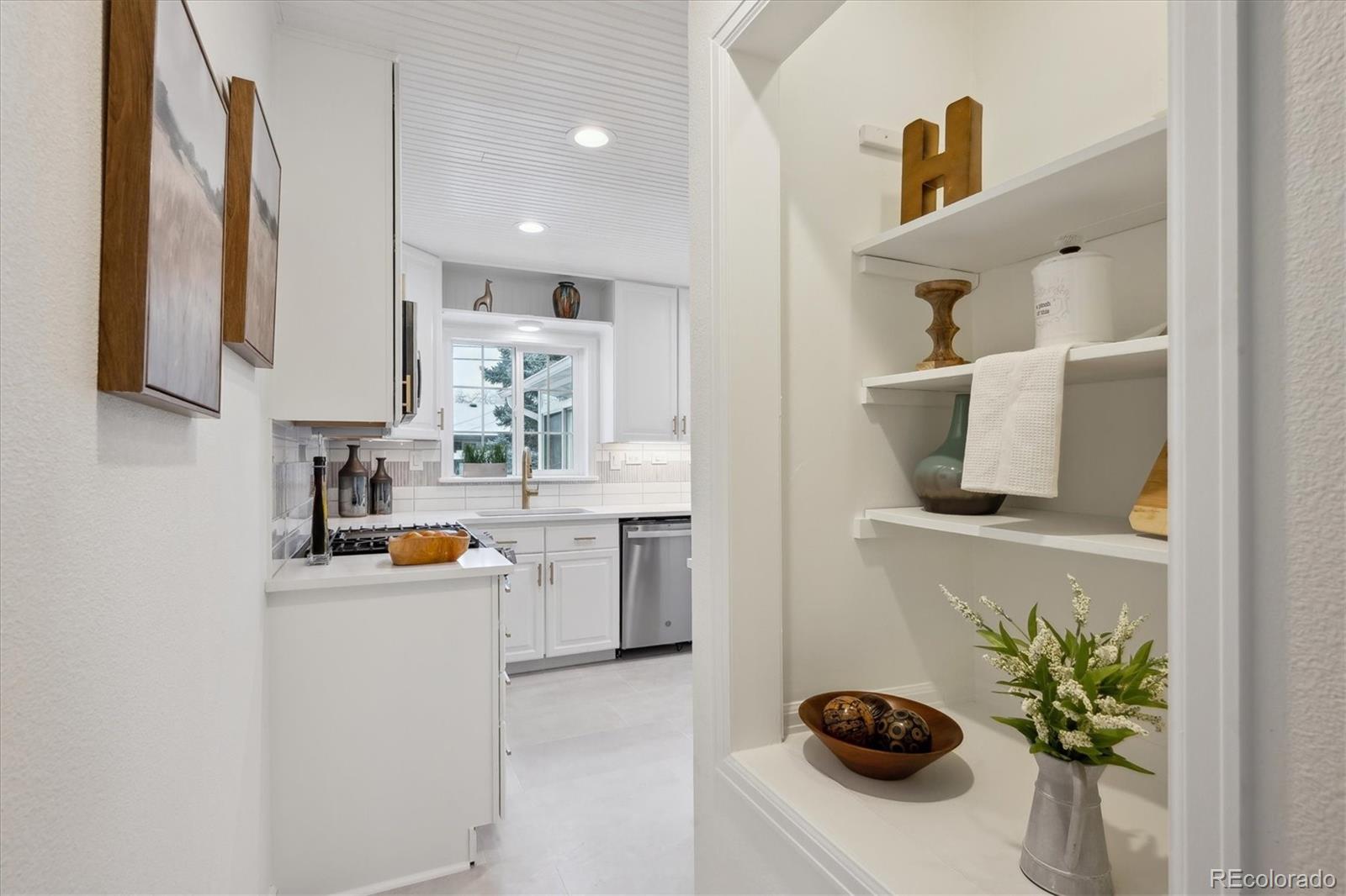 6300 Janice Way Arvada, CO 80004 - Photo 13 of 33 a kitchen with a sink a stove and cabinets