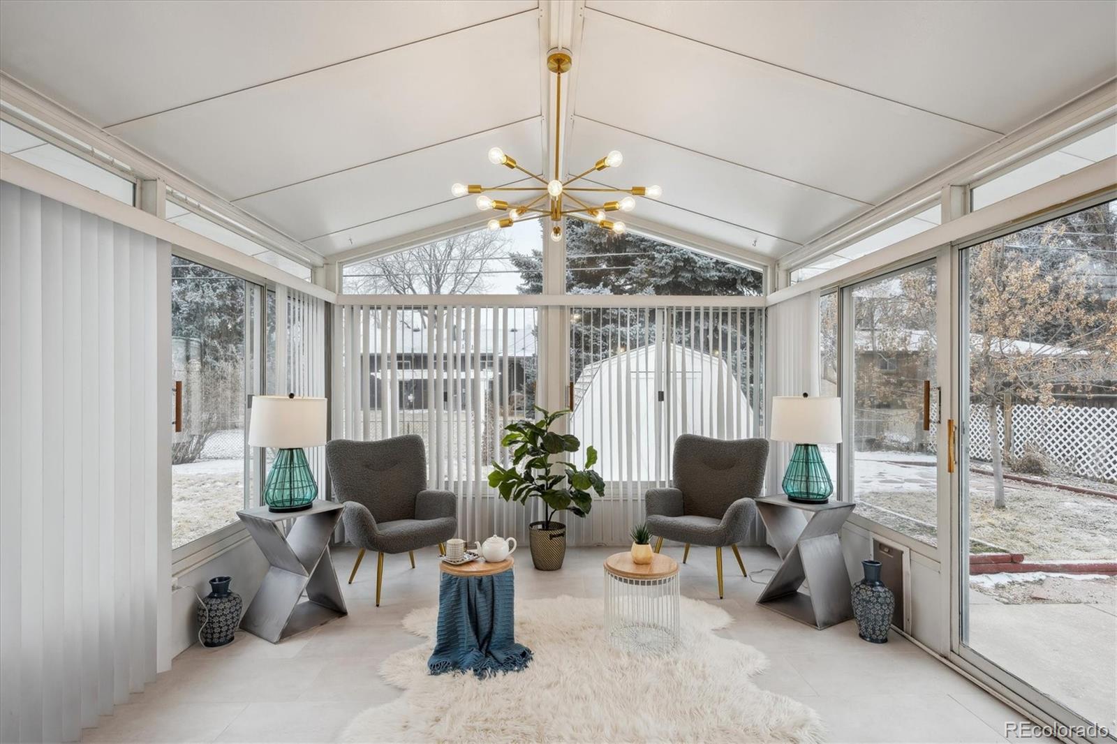 6300 Janice Way Arvada, CO 80004 - Photo 14 of 33 a living room with furniture a chandelier and a large window