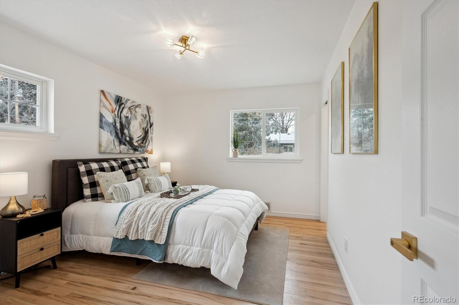 6300 Janice Way Arvada, CO 80004 - Photo 15 of 33 a bedroom with bed and a painting on the wall