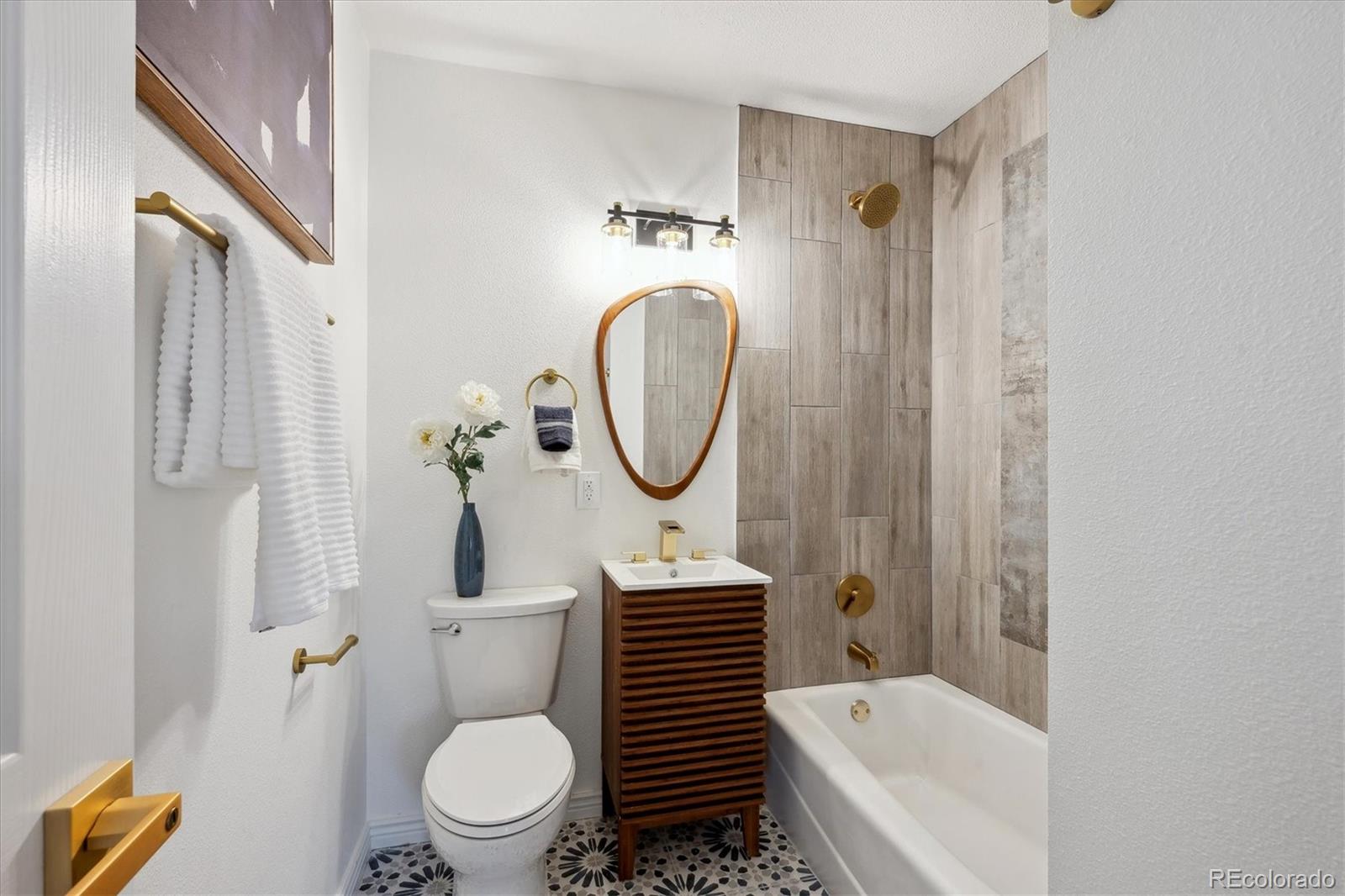 6300 Janice Way Arvada, CO 80004 - Photo 19 of 33 a bathroom with a toilet a sink and a bathtub