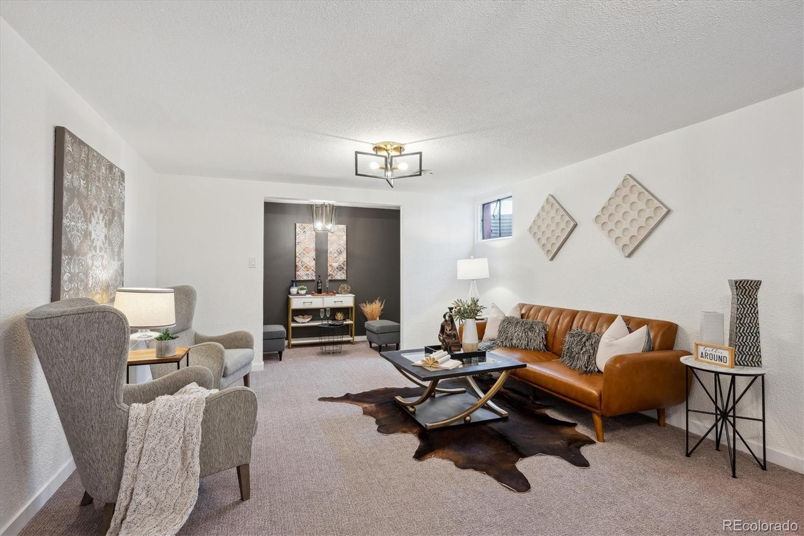 6300 Janice Way Arvada, CO 80004 - Photo 22 of 33 a living room with furniture wooden floor and a lamp