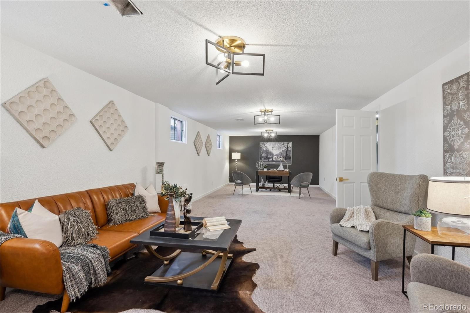 6300 Janice Way Arvada, CO 80004 - Photo 24 of 33 a living room with furniture and a chandelier