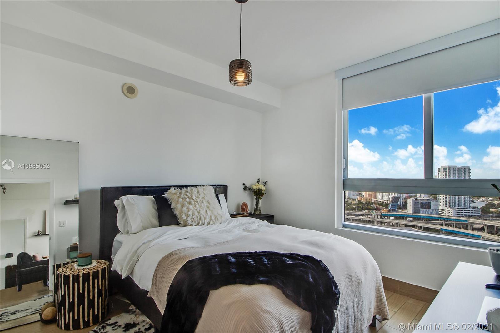 90 Southwest 3rd Street, Unit 2406 Miami, FL 33130 - Photo 4 of 12 a bedroom with a large bed and a window