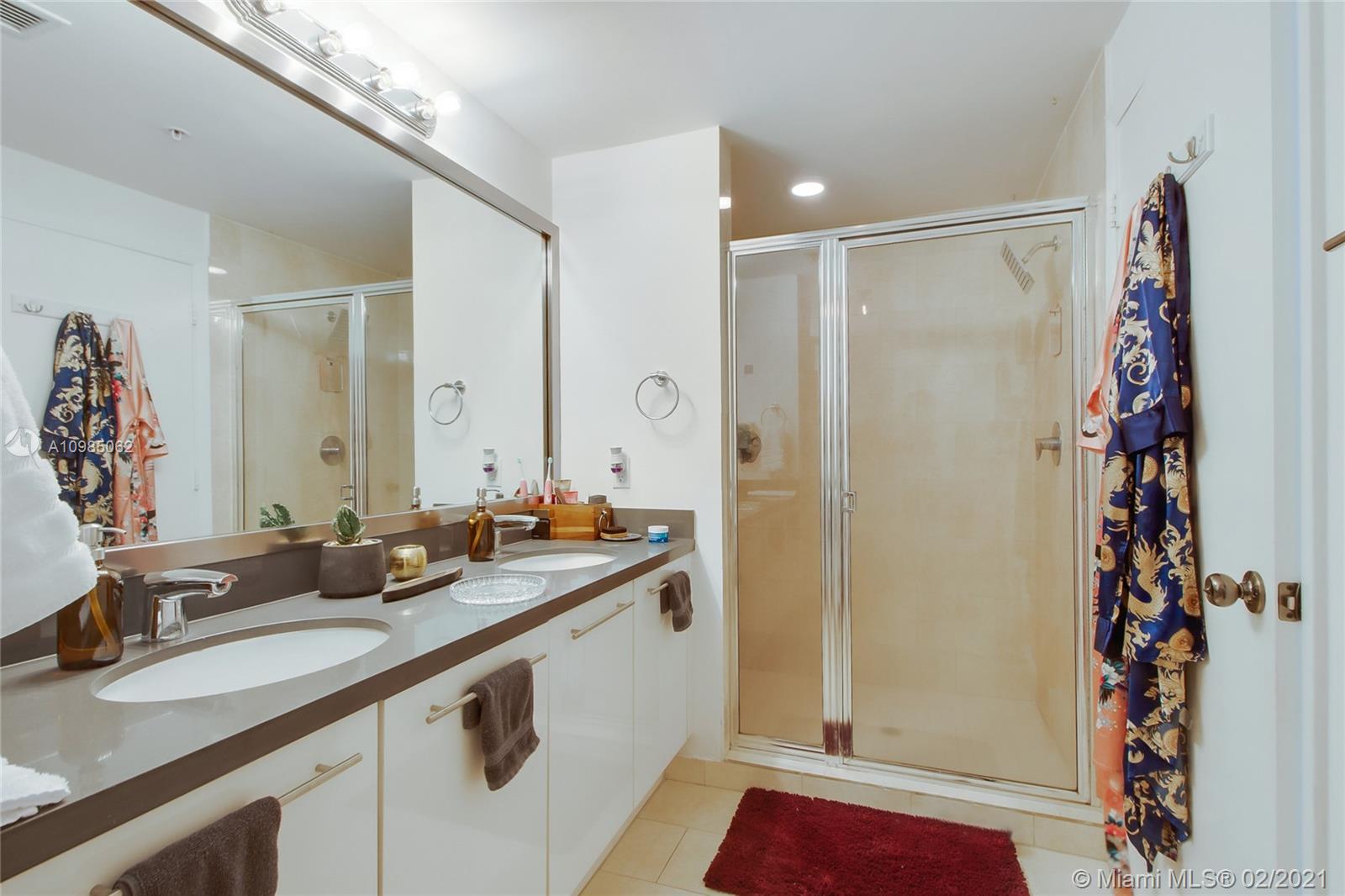 90 Southwest 3rd Street, Unit 2406 Miami, FL 33130 - Photo 5 of 12 a bathroom with a double vanity sink and mirror