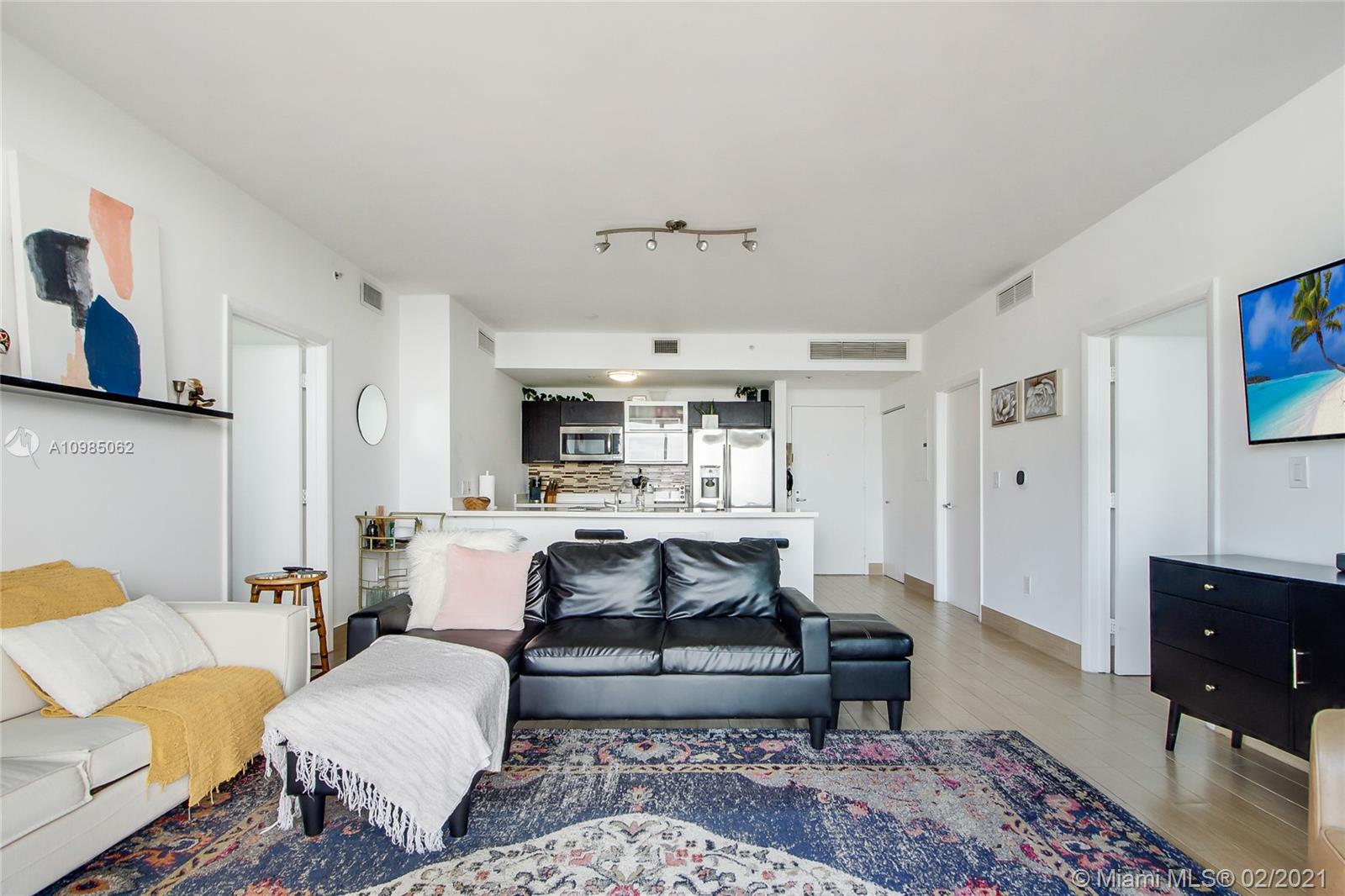 90 Southwest 3rd Street, Unit 2406 Miami, FL 33130 - Photo 6 of 12 a living room with furniture and a rug