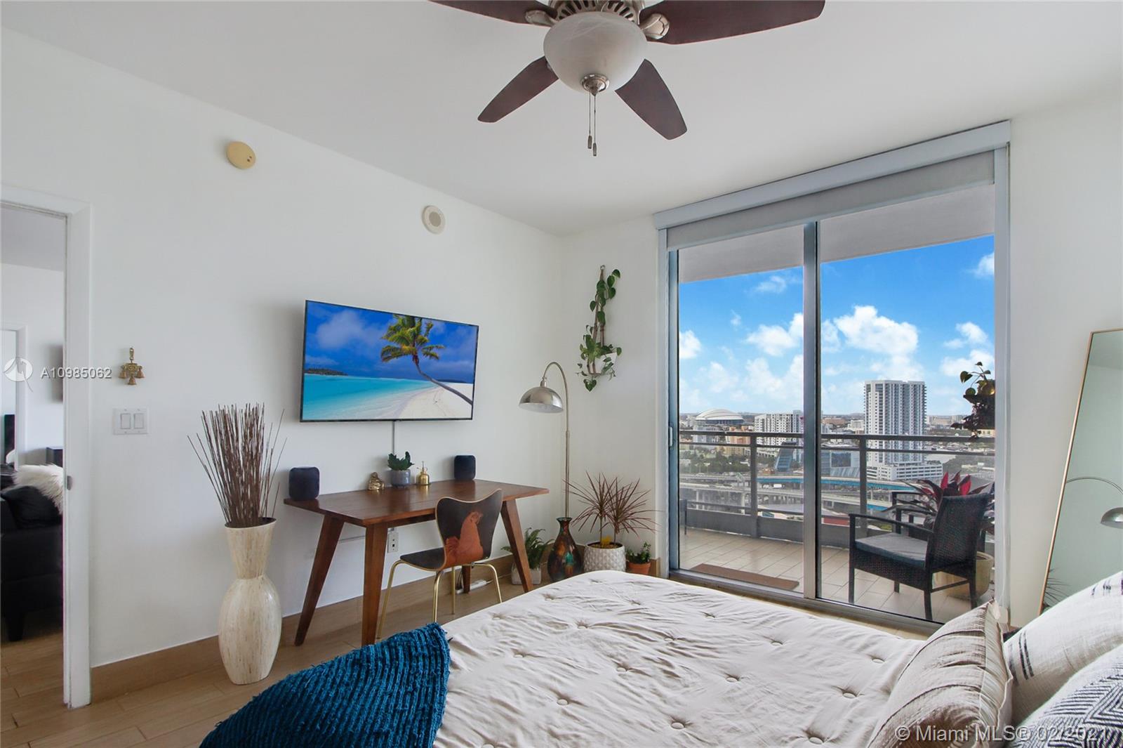 90 Southwest 3rd Street, Unit 2406 Miami, FL 33130 - Photo 8 of 12 a bedroom with a bed and wooden floor