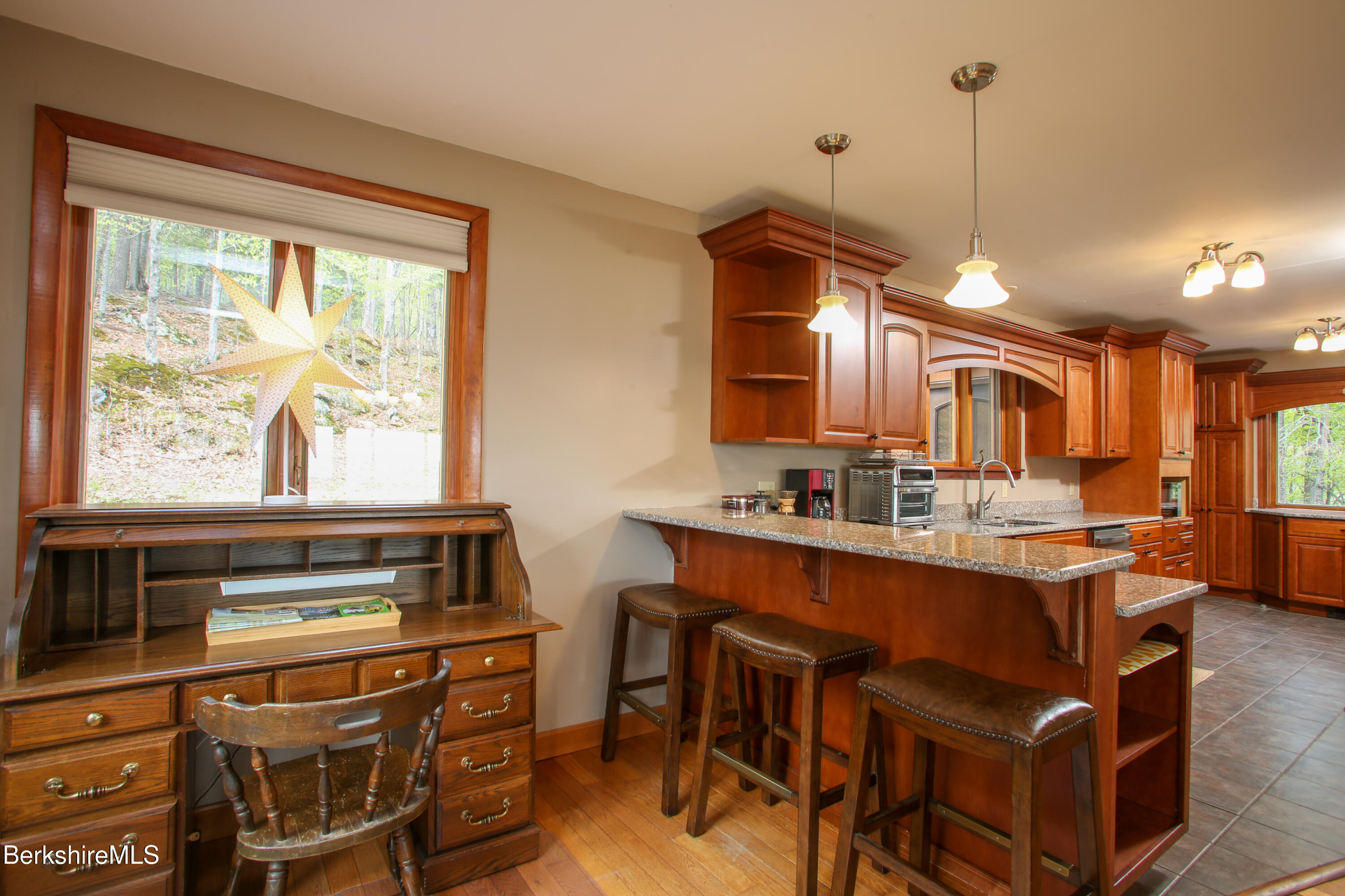 421 Legate Hill Road Charlemont, MA 01339 - Photo 10 of 37 a kitchen with stainless steel appliances a stove a sink dishwasher and a dining table with the view of living room