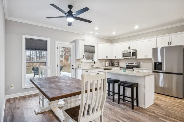 a bedroom with a bed dresser and a chandelier