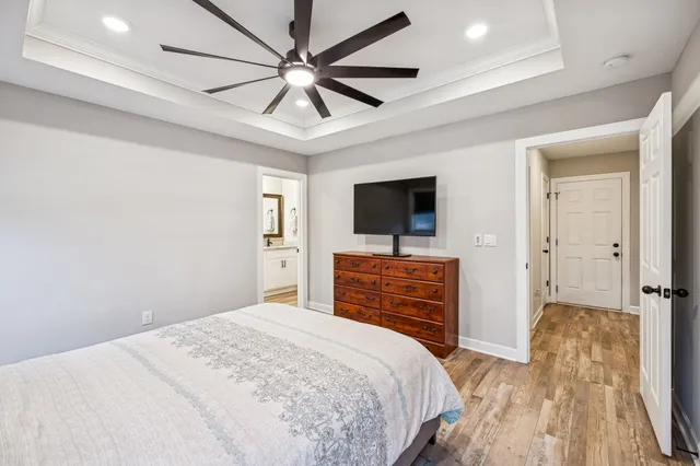 a bathroom with a granite countertop sink mirror vanity and toilet