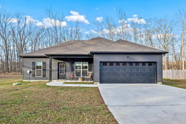 a backyard of a house with outdoor seating