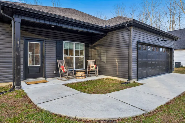 a view of a living room and a livingroom with furniture a ceiling fan