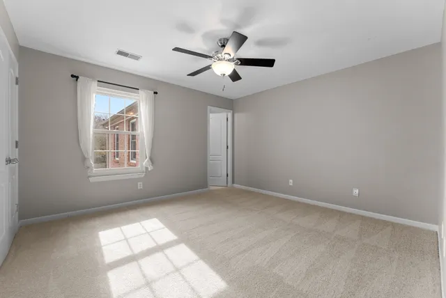 a bathroom with a granite countertop sink a toilet and a mirror