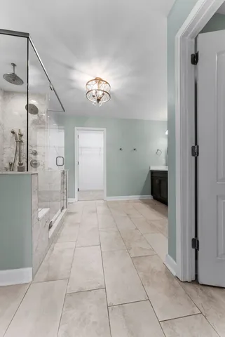 a bathroom with a glass shower door and a sink