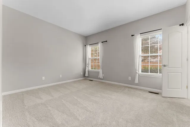 a view of kitchen with furniture and a refrigerator