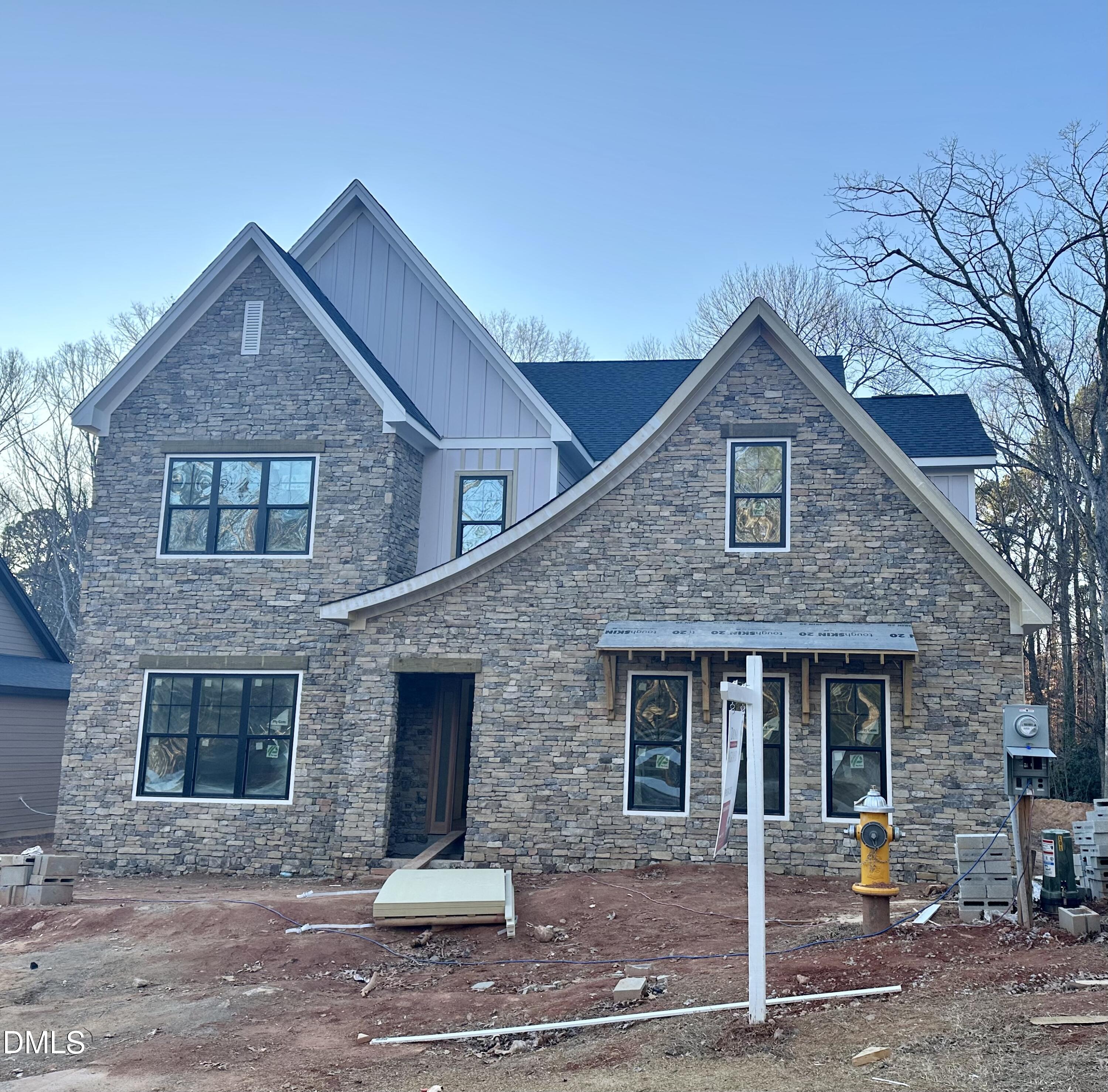 a front view of a house with glass windows and yard