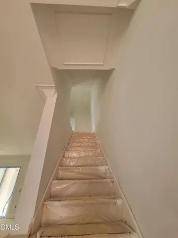 a spacious bedroom with a bed and a large window