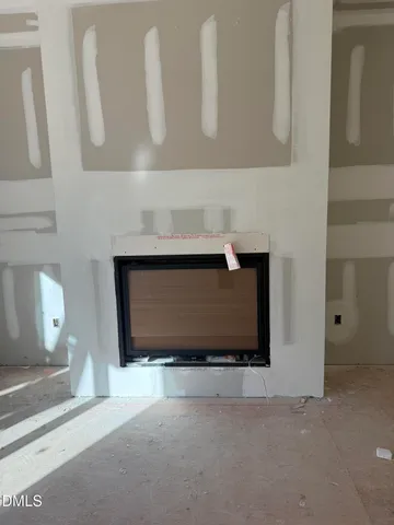 a view of a livingroom with furniture and a fireplace