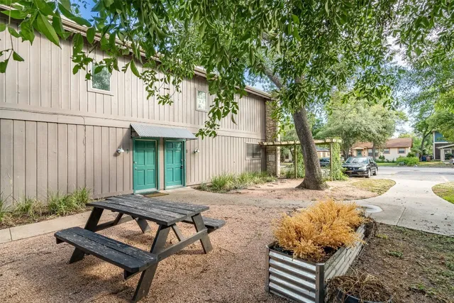 a view of a backyard with sitting area