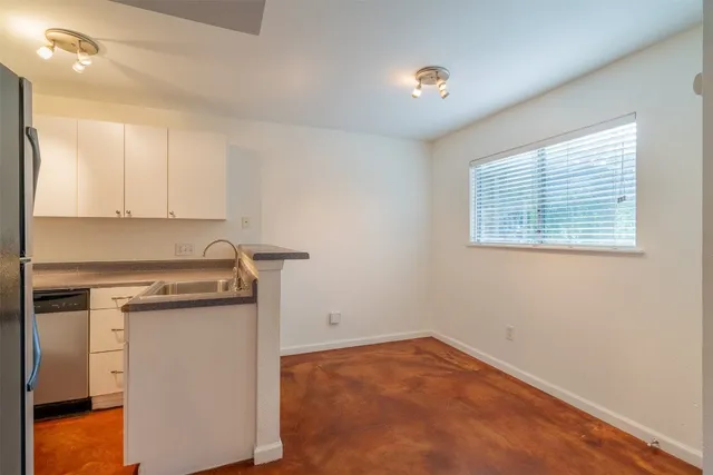 a view of a kitchen with a sink cabinets and a window