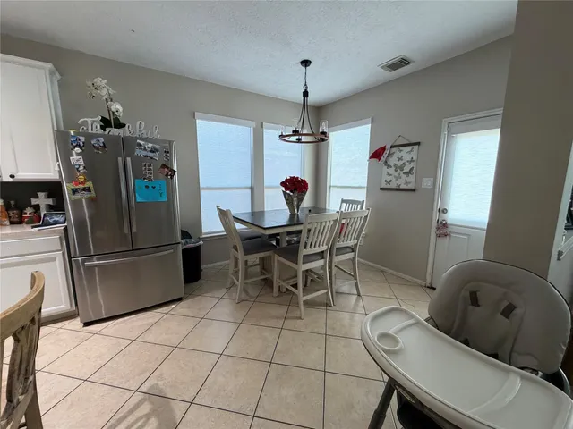 a dining room with furniture and window