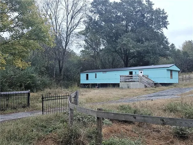 a view of outdoor space with green field and trees