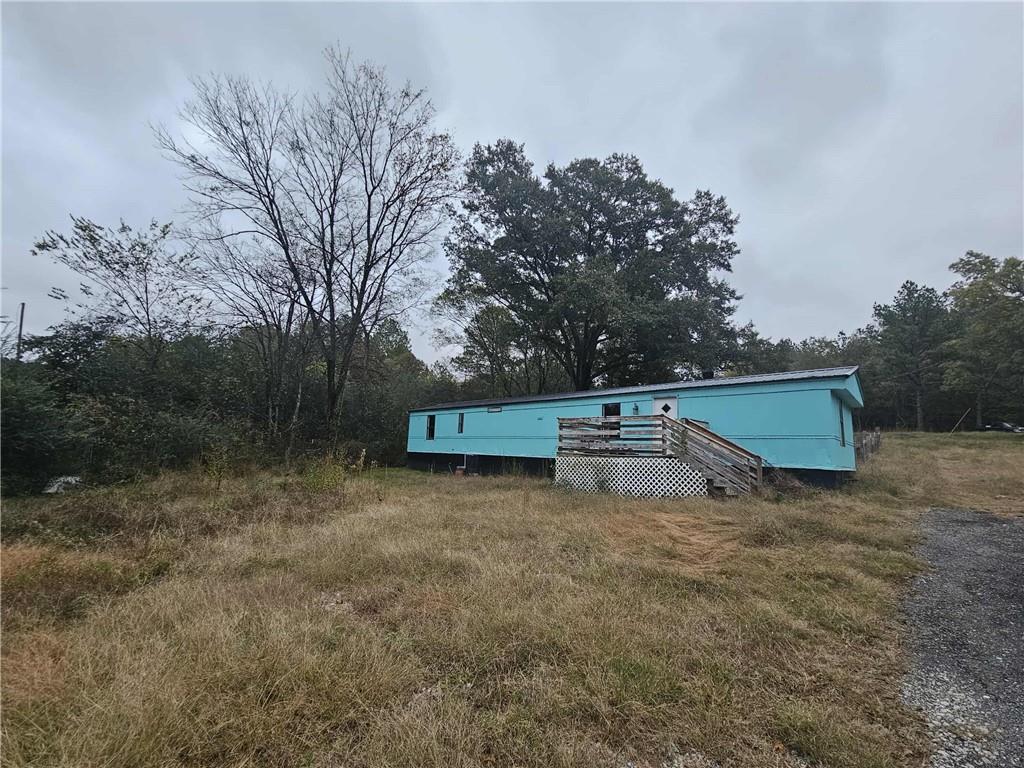 2081 Blacks Bluff Road Southwest Rome, GA 30161 - Photo 10 of 13 a backyard of a house with wooden fence and large trees
